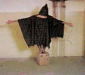 A hooded and wired Iraqi prisoner at Abu Ghraib prison is pictured this undated photo. Defense Secretary Donald Rumsfeld may move to extend the investigation of abuses of Iraqi prisoners to include top military ranks, defense officials said on June 10, 2004. Rumsfeld is considering a request by the commander of U.S. forces in the Middle East to replace a two-star Army general investigating the prisoner abuse scandal. Photo by The New Yorker/Reuters
