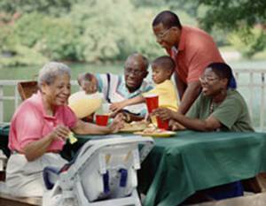 African American family of 3 generations (grandparents, parents, grandchildren) having a picnic