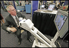 Donald Spatch, of the U.S. Department of Veterans Affairs, demonstrates Game Cycle, which helps seniors build and maintain upper-body strength.