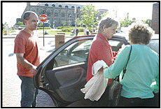 Neighbor Ride volunteer Gontran Lamberty picks up Ann Hiban, center, and Eleanor Jose at the Meyerhoff Symphony Hall in Baltimore.