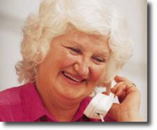 picture of an elderly lady smiling and talking on the telephone