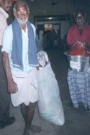 Photo: Perumal receives aid Nidhi Raj Kapoor/HelpAge India