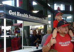 [Booth at Boston's Fenway Park offering health coverage to the uninsured]