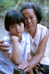 A Thai grandmother takes care of her granddaughter whose parents both died of AIDS. Sankampaeng, Chiang Mai Province, Thailand.
