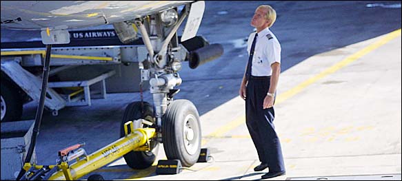 A US Airways pilot at San Francisco International Airport. The government and the airline disagree on how a pension fund for pilots should be assessed. If the airline's method prevails, the pilots could lose more.