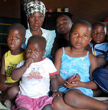Older African woman with some of the grandchildren she cares for. Photo: Leila Amanpour/HelpAge International.