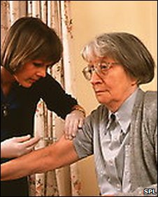 elderly woman being given an injection