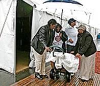 Volunteers, from left, Mary Schulthels, Kathy Morris, Merri Roussell and Aggie Williams try to keep supplies dry at a health fair in New Orleans.