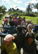 Villagers are seen on a truck as they evacuate from Srumbung village, about 6 km (4 miles) from Indonesia's Mount Merapi in Yogyakarta, central Java May 14, 2006. Dozens of Indonesian villagers tried to return to their homes on the slopes of Mount Merapi on Sunday despite an official order to evacuate over concerns the dangerous volcano could soon erupt.  