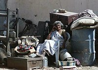 Surrounded by her belongings an old 
woman waits for transport even as mild 
tremors continue to shake the town of 
Morbi,  250 km northwest of Ahmedabad, 
January 29, 2001.  Around 300 people 
have been killed in the town and 
thousands of buildings have been 
rendered unsafe. An estimated 20,000 
people are believed to have been killed 
in the earthquake that ravaged western 
India on January 26.   REUTERS/Savita 
Kirloskar