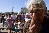 An elderly woman prays during a mass in 
memory of earthquake victims in the 
shelter El Cafetalon in Santa Tecla, 
January 21, 2001. On January 13, a 7.6 
Richter scale earthquake rocked El 
Salvador destoying some 46,000  homes 
and killing more than 700 people.    
REUTERS/Jorge 
Silva
