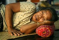 A tribal woman from the remote Car 
Nicobar island rests inside a tsunami 
relief camp in Port Blair January 8, 
2005. The Reserve Bank of India eased 
rules for lending money to tsunami 
victims on Saturday and advised banks to 
do more to provide financial aid in 
affected areas. REUTERS/Jayanta 
Shaw