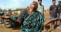 An Indian woman wails after her house 
was damaged near the Marina beach when a 
tsunami hit the southern Indian city of 
Madras December 26, 2004. At least 1,000 
people have been killed after a tsunami 
triggered by an earthquake in the Indian 
Ocean hit India's southern coast on 
Sunday, Interior Minister Shiv Raj Patil 
told Aaj Tak television.  REUTERS/
Babu