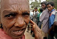 An elderly tsunami victim waits in line 
to receive relief supplies in 
Nagapattinam, in the southern Tamil Nadu 
state, January 10, 2005. At least 156,
000 people were killed across Asia by 
the December 26 earthquake and 
subsequent tsunami, the most widespread 
natural disaster in living memory. Well 
over 100,000 are missing, and there is 
little hope of finding many of them 
alive. REUTERS/Kamal 
Kishore
