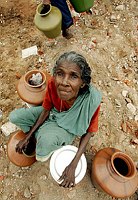 A tsunami victim sits next to utensils 
given out at a relief camp at a fishing 
hamlet in Nagapattinam, in the southern 
Indian state of Tamil Nadu, January 19, 
2005. India's overall death toll from 
Dec. 26 devastation has risen to more 
than 16,000.   REUTERS/Kamal 
Kishore