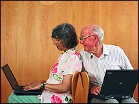 Elderly people using laptops