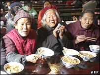 Elderly Buddhists eat in meal in the dining hall of a temple in Chengdu, China (10/12/2007)
